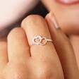 A Close Up Image of a Model Wearing a Slim Band Silver Ring With Heart Details