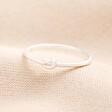 A Sterling silver ring with a tiny knot detail on Neutral Fabric