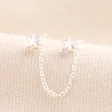 A charming pair of connecting earrings that attach two piercing holes via a chain.