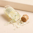 Yellow Crystals Spilling From Small Glass Bottle With Cork Stopper Open