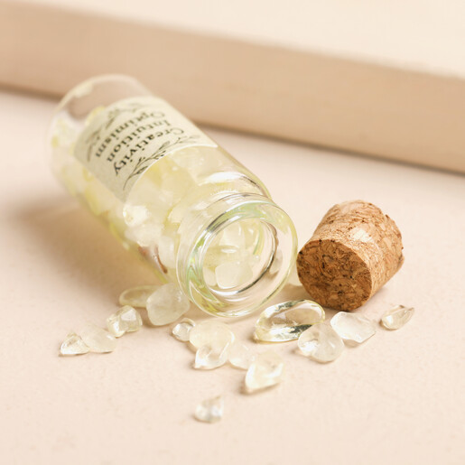 Yellow Crystals Spilling From Small Glass Bottle With Cork Stopper Open
