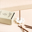 Image showing a ceramic floral incense holder, incense sticks and beige matchbox holder