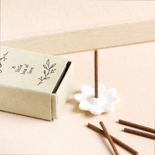Image showing a ceramic floral incense holder, incense sticks and beige matchbox holder