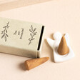 Image of the porcelain angel incense holder along with two incense cones and matchbox packaging