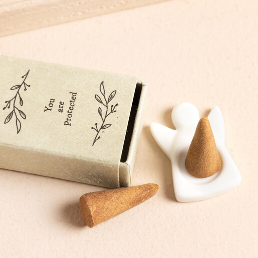 Image of the porcelain angel incense holder along with two incense cones and matchbox packaging