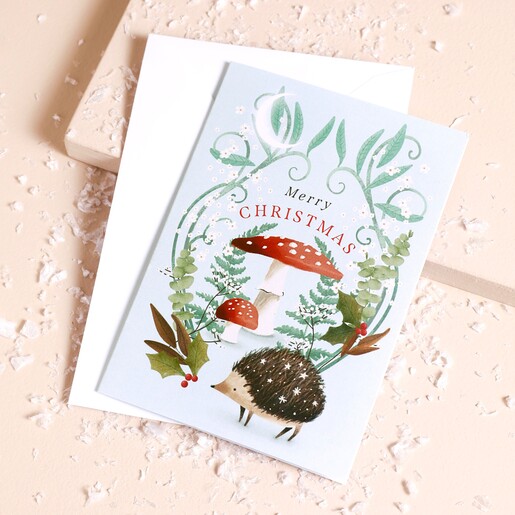 A light blue card with a toadstool, hedegehog,and nature design
