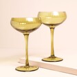 A set of two lime coloured glasses with stems