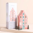 A tall, pink house shaped incense cone or tea light holder