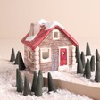 A charming house shaped holder with a red roof, door and 20 incense cones shaped like trees