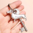 Lancaster & Gibbings Dachshund Keyring with a key on a neutral background