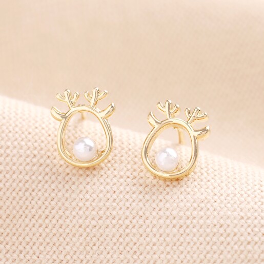 Studs in the shape of a gold reindeer outline with a pearl nose
