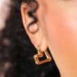 Close Up of Organic Heart Hoop Earrings in Gold on Model