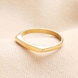 Stainless Steel Slim Signet Ring in Gold against Beige Background