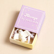 Tiny Matchbox Ceramic Angel Token on Beige Background