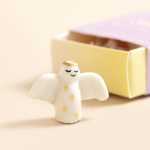 Close Up Close Up of Tiny Matchbox Ceramic Angel Token