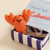 Close Up of Tiny Matchbox Ceramic Lobster Token