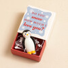 Tiny Matchbox Ceramic Penguin Token on a Beige Background