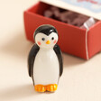 Close Up of Tiny Matchbox Ceramic Penguin Token