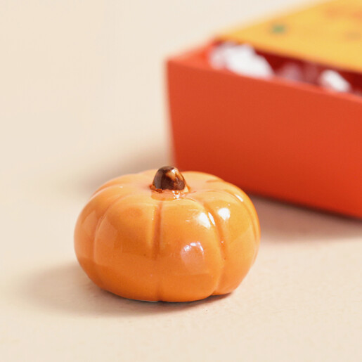 Close Up Close Up of Tiny Matchbox Ceramic Pumpkin Token