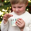 Child holding the festive mug