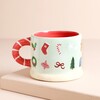 The festive mug with candlycane handle on a beige background