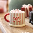 Close up A Stripy Cream Green and Red Mug With a Red Handle Filled With Hot Chocolate and Marshmallows