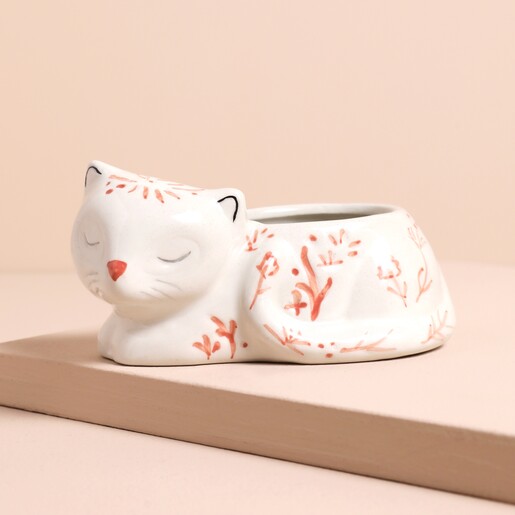 Pink and White Floral Sleeping Cat Planter on a beige background