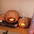 Pumpkin Starry Ceramic Wax Burners with burning tealights on a simple backdrop