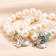 Large 20th Anniversary Pearl Charm Bracelet with Gold Charms Alongside 20th Anniversary Pearl Charm Bracelet with Silver Charms on Neutral Fabric