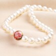 Small 20th Anniversary Pearl Necklace With Red Tensha Bead on Neutral Fabric