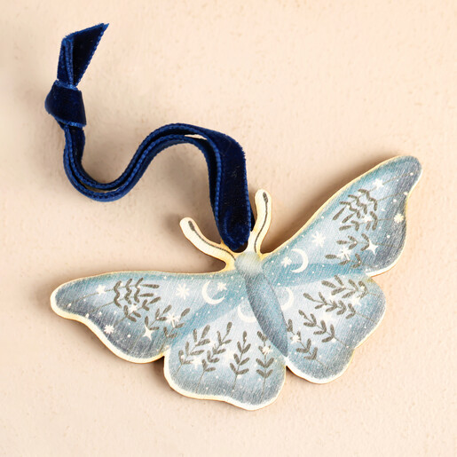 Wooden Butterfly Hanging Decoration Against Beige Backgrounf