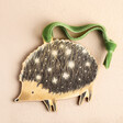 Wooden Hedgehog Hanging Decoration Against Beige Backgrounf