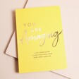 A travel-sized yellow guide book packed with mindfulness tips and uplifting quotes