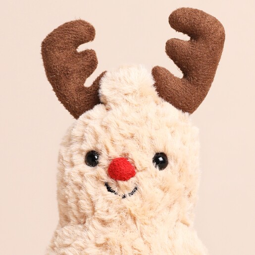 Close up of Jellycat Amuesables Peanut Reindeer Soft Toy with a red nose, brown boots and brown antlers