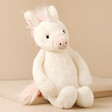 Jellycat Bashful Unicorn Soft Toy Against Beige Background