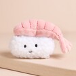 A small white smiling face rectangle rice ball with a pink prawn hanging over the top.