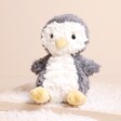 Jellycat Yummy Penguin Soft Toy sitting on a neutral colour background