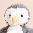 Jellycat Yummy Penguin Soft Toy close up of face with beaded black eyes and yellow beak