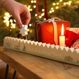 Wooden Norwich Christmas Countdown on a Beige Background.