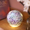 A charming round nightlight with dark purple star shaped sparkles.