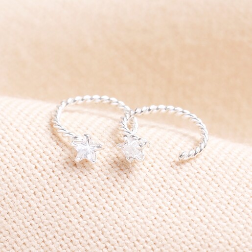 Sterling Silver Crystal Star Twisted Huggie Hoop Earrings Sterling Silver Crystal Star Twisted Huggie Hoop Earrings on a beige background