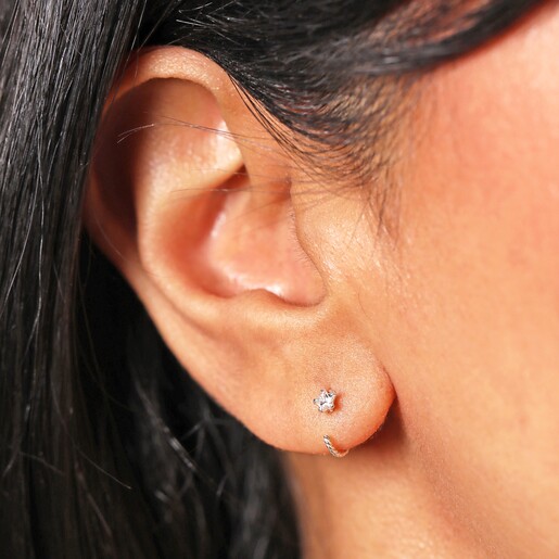 Close up model Shot Close up shot of model wearing Sterling Silver Crystal Star Twisted Huggie Hoop Earrings