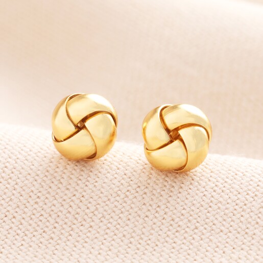 Sterling Silver Knot Stud Earrings in Gold on Beige Background