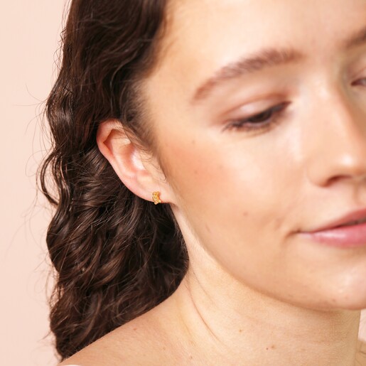 Model Shot Model Shot of Sterling Silver Turtle Stud Earrings in Gold on Beige Background