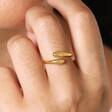 Close Up of Adjustable Sterling Silver Teardrop Wrap Ring in Gold on Model