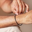 Close Up of Men's Braided Vegan Leather T-Bar Bracelet in Black on Model