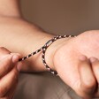 Close Up of Personalised Men's Pull Cord Rope Bracelet in Black on Model