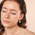 Model Shot of Tapered Oval Hoop Earrings in Gold