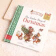 Brown Bear Wood The Twelve Days of Christmas Book with a green leaf border and an illustration of Bear with Christmas tree and woodland friends