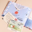 Inside pages with writing and illustrations and removable letters